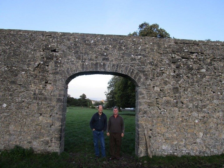 Bill and Liam Maher at gate to property